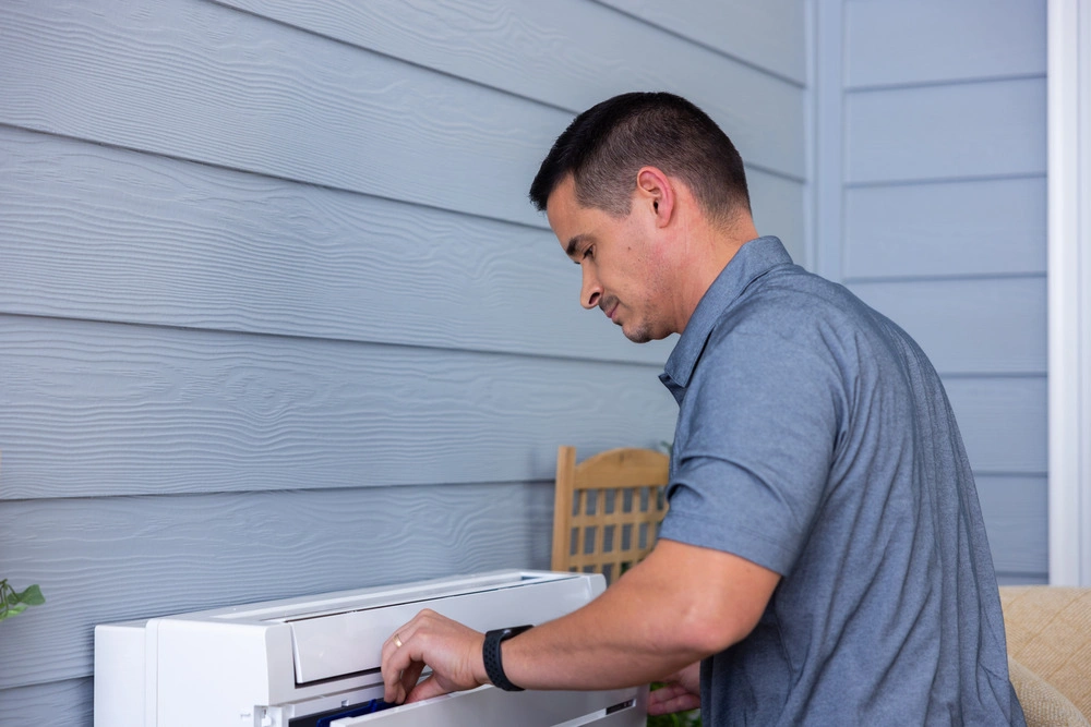 HVAC technician servicing a mini-split system