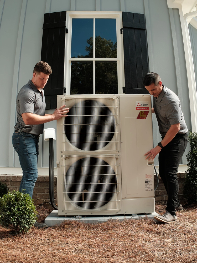 Technicians installing a geothermal heat pump system